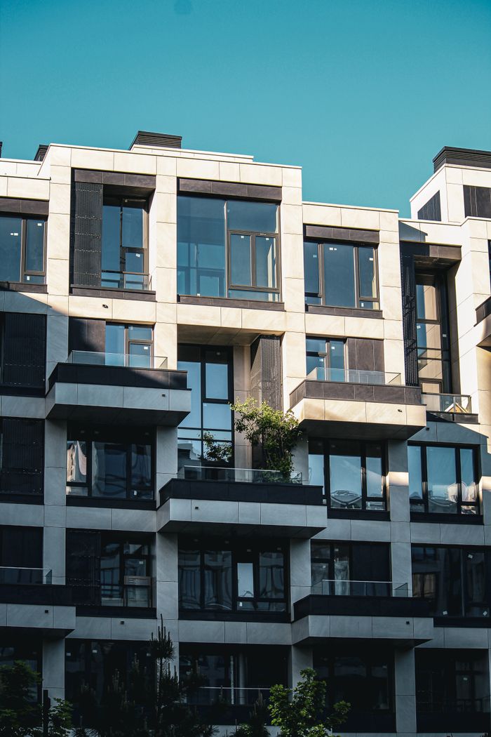 Crafting Captivating Headlines: Your awesome post title goes here Contemporary apartment building facade with balconies and clear blue sky.