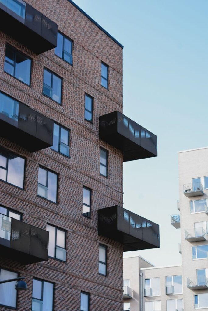 Contemporary brick apartment building with balconies in Denmark, showcasing urban architecture.